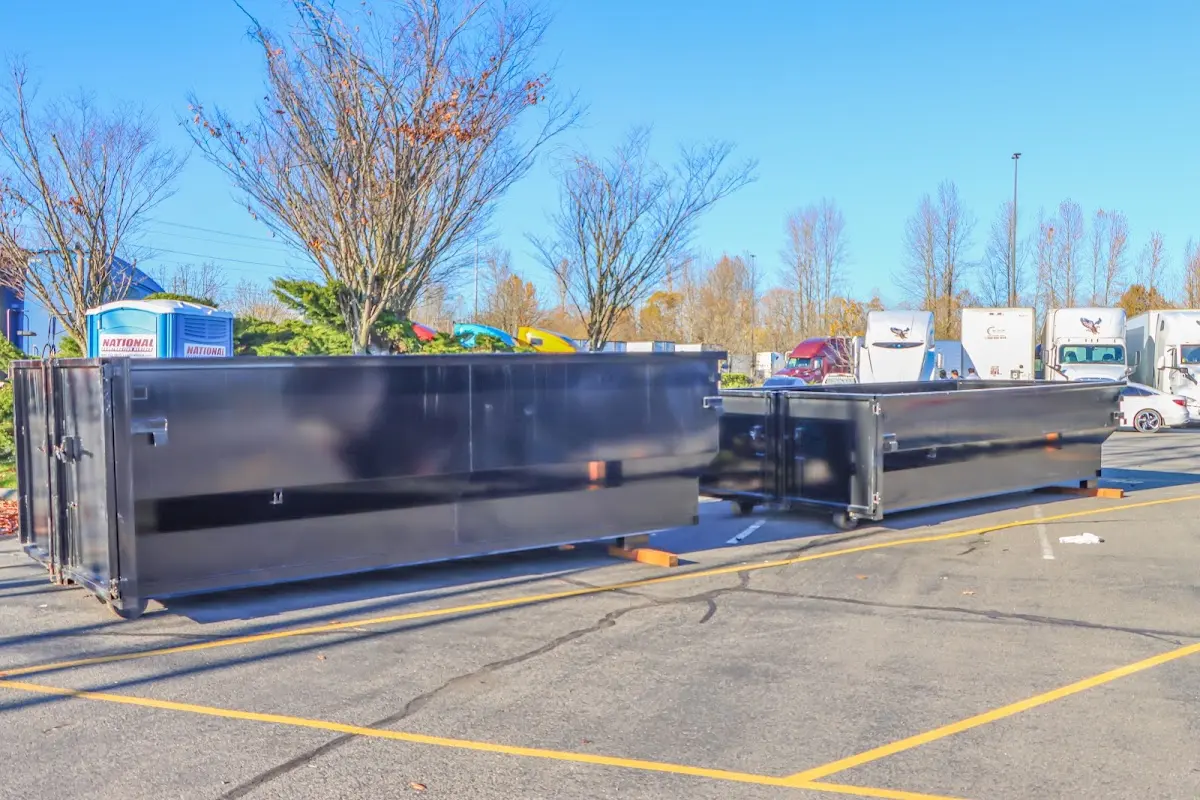 Professional dumpster rental service with roll-off container on residential driveway in Kearny